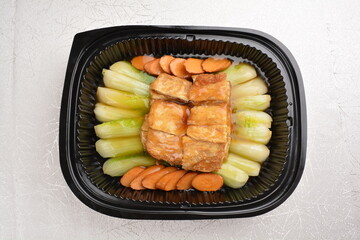 stir fried cabbage vegetable with bean curd tofu skin, carrot and mushroom in oyster sauce in party bento tray box for asian take away halal menu