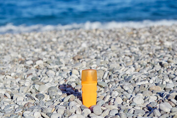 Mock up of sun cream on the pebbles. Top view. Concept of spa, cosmetic, suncream and moisturizer