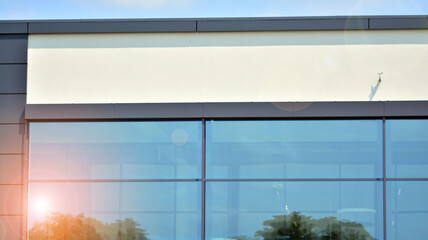 The glazed facade of an office building with reflected sky. Modern architecture buildings exterior 