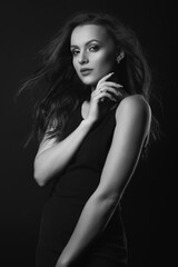 Naklejka premium Stylish studio portrait of a stylish brunette woman with perfect makeup