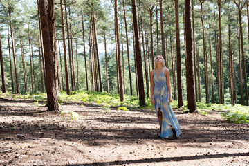 beautiful girl walking through a forest