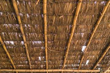 Old dry grass roof with bamboo beam structure