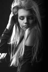 Black and white portrait of a beautiful woman with bare shoulders