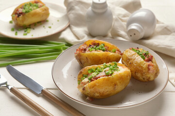 Plate with baked potato on table
