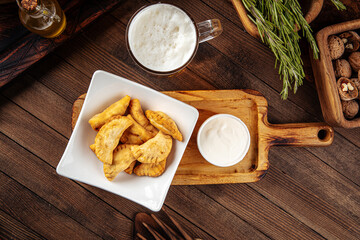 Plate of fried chebureks meat stuffed pies on wooden background