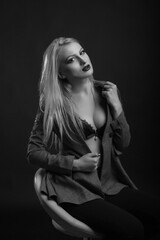 Fashionable model wears bra and jacket posing at studio