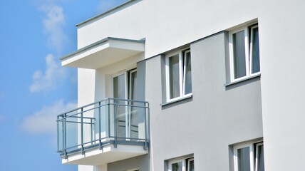  Modern apartment buildings on a sunny day with a blue sky. Facade of a modern apartment building. Glass surface with sunlight.