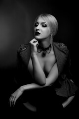 Fototapeta premium Stylish studio shot of a beautiful lady wears jacket on a naked body