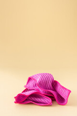 Pink microfiber cloth for washing on a neutral beige background, cleaning concept