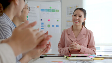 Small group asia female young happy people, sale team work in reskill upskill training class share plan idea in project research job feel bonding thankful respect greeting smile sit in office room.