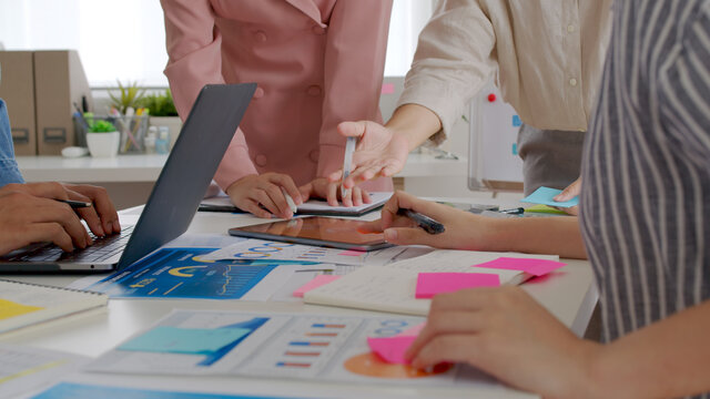 Close-up hand small group asian young adult people sale staff work share idea on desk table in happy workplace workforce concept training reskill upskill team building class at board room home office.