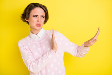 Photo of young woman dissatisfied negative show no stop sign look empty space isolated over yellow...