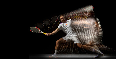 Portrait of young man, male tennis player in motion and action isolated on dark background....