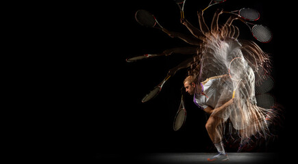 Portrait of young man, male tennis player in motion and action isolated on dark background....