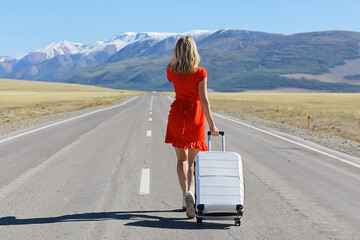 sexy girl in dress with suitcase on the highway, summer travel freedom, woman tourist