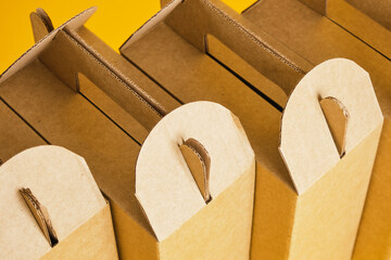 several cardboard boxes on a yellow background, boxes for a gift or product delivery without a logo