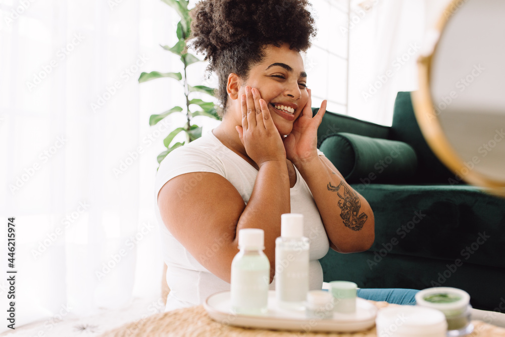 Wall mural smiling woman doing skin care at home