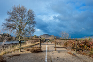 Abandoned section of road on a cloudy winter day on a stretch up the snowy mountain