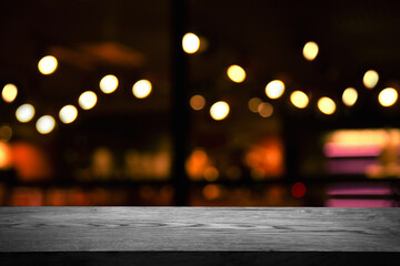 blurred cafe, reflected in the window, empty wooden black table.