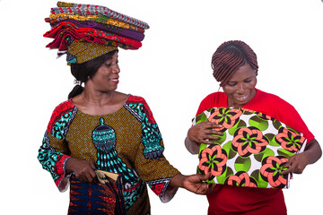 beautiful woman showing different traditional loincloths to a client while smiling.