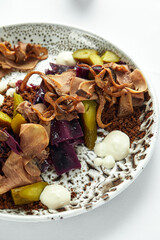 Beef tongue with pickle close-up on a light plate.