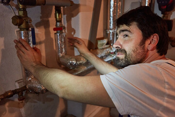 Installer checks the insulation of the water pipes
