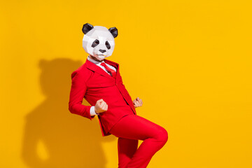 Photo of astonished triumphant guy rejoice wear panda mask red suit tie isolated on yellow color...