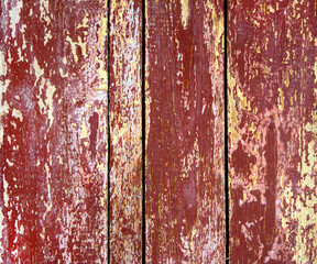 The texture of the wooden surface with old red paint.