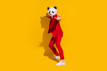 Photo of panda guy crazy party funny dance wear mask red tux tie shoes isolated on yellow color...
