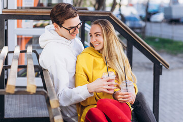 Couple drink coffee in transparent cups.