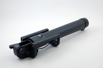 Black selfie stick with shutter button