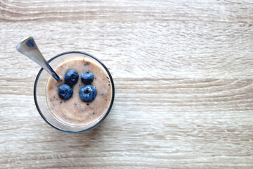 Banana and blueberry vegan nice cream, served on wooden table. Flat lay.