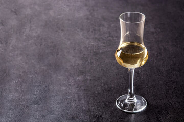 Italian golden grappa drink on black  background