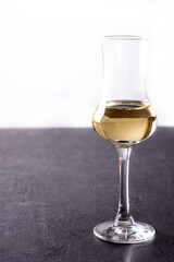 Italian golden grappa drink on black  background