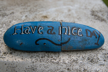 Closeup shot of a rock with the text 'Have a nice day'