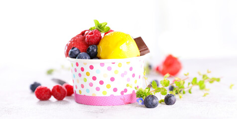 bowl of ice cream scoop and berry