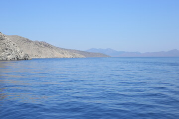Fototapeta na wymiar seashore rocky mediterranean landscape waves boat engine