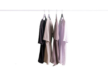 some new t - shirts collection hang on the hanger rack, sale and retail concept, isolated white background