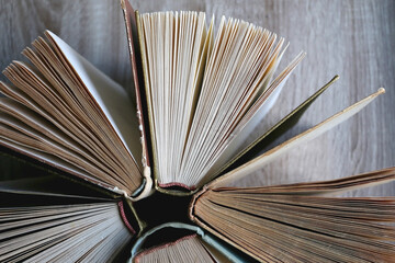 Vintage hardcover books on a wooden table. Top view.