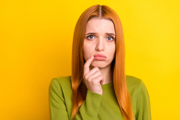 Photo of sad red hair young lady finger chin wear green sweater isolated on yellow color background