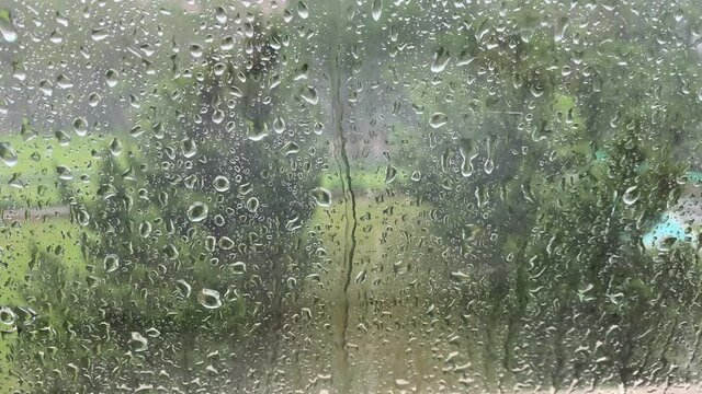 Raindrops falling on a window.