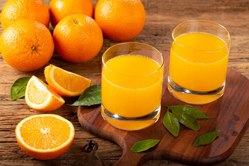 Glass with orange juice on the table.