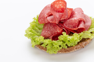 Sandwich with salami sausage on white background.
