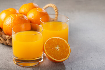 Glass with orange juice on the table.