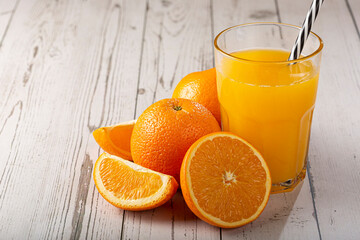 Glass with orange juice on the table.