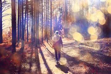 female sports style autumn forest, fitness tourism in a yellow park leaf fall sun