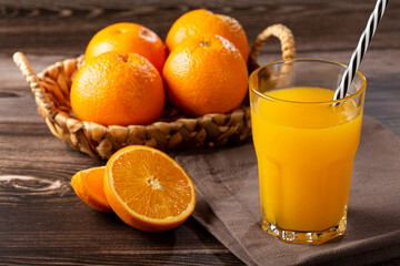 Glass with orange juice on the table.
