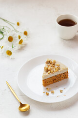 Slice of vegan carrot cake with coconut cream and walnuts no baked. Sugar, gluten and lactose free.