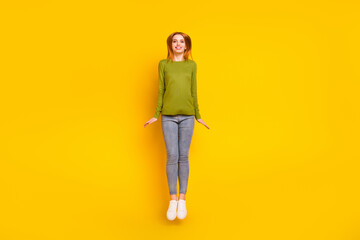 Fototapeta premium Full length body size photo jumping up smiling happy isolated vibrant yellow color background