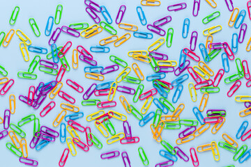 Paper color clip notebook on blue background. Flat lay.